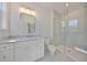 Bathroom featuring white marble countertops, updated vanity, and glass shower at 3913 W Euclid Ave, Tampa, FL 33629