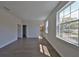 Bedroom with hardwood flooring, natural light, view into adjacent bathroom at 3913 W Euclid Ave, Tampa, FL 33629