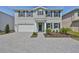 Charming two-story home features a large brick driveway, attached garage, manicured lawn, and classic black shutters at 3913 W Euclid Ave, Tampa, FL 33629
