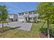 Beautiful two-story home with a gray brick driveway, manicured lawn, and inviting curb appeal at 3913 W Euclid Ave, Tampa, FL 33629