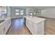 Spacious kitchen featuring a large island with a farmhouse sink and elegant gold hardware at 3913 W Euclid Ave, Tampa, FL 33629