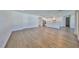 Open-concept living room and kitchen area with beautiful hardwood floors and natural light at 3913 W Euclid Ave, Tampa, FL 33629