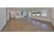 Spacious living room with hardwood floors leading to a modern, all-white kitchen at 3913 W Euclid Ave, Tampa, FL 33629