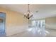 Bright living room featuring a decorative chandelier, and large windows at 3933 Doral Dr, Tampa, FL 33634