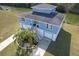 Aerial view of home with water views, lush landscaping, and double driveways at 4010 Jewfish Dr, Hernando Beach, FL 34607