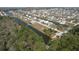 Scenic aerial view of waterfront homes with canal access, set amidst lush greenery and a tranquil atmosphere at 4010 Jewfish Dr, Hernando Beach, FL 34607