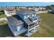 Aerial view of blue home with covered porch and balcony at 4010 Jewfish Dr, Hernando Beach, FL 34607