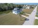 Aerial view of blue home on a canal, with lush green surroundings and a dock at 4010 Jewfish Dr, Hernando Beach, FL 34607