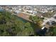 Beautiful aerial shot of a waterfront community, highlighting canal access and surrounding wooded areas at 4010 Jewfish Dr, Hernando Beach, FL 34607