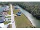 Aerial view of the charming blue waterfront home, showcasing its spacious yard and serene location at 4010 Jewfish Dr, Hernando Beach, FL 34607