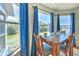Dining area with water view, wood table, and blue curtains at 4010 Jewfish Dr, Hernando Beach, FL 34607