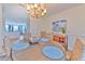 Elegant dining room with wood table, wicker chairs, and stylish chandelier at 4010 Jewfish Dr, Hernando Beach, FL 34607