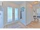 Inviting entryway with decorative glass front door and wood-look flooring at 4010 Jewfish Dr, Hernando Beach, FL 34607
