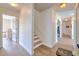 Hallway view of guest bedroom, bathroom, and staircase with wood steps at 4010 Jewfish Dr, Hernando Beach, FL 34607