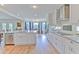 Open kitchen with white cabinets, stainless appliances, and a view to the dining area at 4010 Jewfish Dr, Hernando Beach, FL 34607