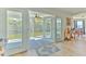 Open doors leading from a living area to a waterfront screened-in porch at 4010 Jewfish Dr, Hernando Beach, FL 34607