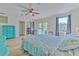 Bright main bedroom with light wood floors, ensuite office, and French door to deck at 4010 Jewfish Dr, Hernando Beach, FL 34607