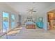 Bright main bedroom with deck access, ceiling fan, and coastal-themed decor at 4010 Jewfish Dr, Hernando Beach, FL 34607