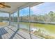 Serene waterfront views from the screened-in porch with wood-look flooring at 4010 Jewfish Dr, Hernando Beach, FL 34607