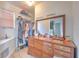 View of the walk-in closet area adjacent to the primary bathroom with a dresser at 4010 Jewfish Dr, Hernando Beach, FL 34607