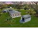 Aerial view of a home with a large yard, shed, and peaceful surroundings, offering a serene and spacious living environment at 4100 Ernest Dr, Wesley Chapel, FL 33543