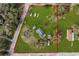 Expansive lot with a cozy home, outbuildings, and ample green space, ideal for outdoor enjoyment and privacy at 4100 Ernest Dr, Wesley Chapel, FL 33543