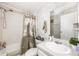Cozy bathroom with patterned shower curtain and essential fixtures including vanity, toilet and shower at 4100 Ernest Dr, Wesley Chapel, FL 33543