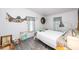 Bright bedroom with beachy decor, featuring unique wall art and hardwood floors at 4100 Ernest Dr, Wesley Chapel, FL 33543