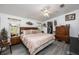 Inviting bedroom featuring a comfortable bed, wooden furniture, and closet at 4100 Ernest Dr, Wesley Chapel, FL 33543