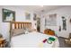 Comfortable bedroom with wooden headboard, eclectic artwork, and natural light at 4100 Ernest Dr, Wesley Chapel, FL 33543