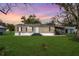 Cozy single-story home featuring a well-kept lawn, covered parking, and charming curb appeal for comfortable living at 4100 Ernest Dr, Wesley Chapel, FL 33543