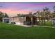 Charming home with a covered patio, perfect for outdoor entertaining and relaxing in a serene backyard setting at 4100 Ernest Dr, Wesley Chapel, FL 33543