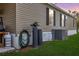 The home features neutral siding, black shutters, and well-maintained lawn and external utilities at 4100 Ernest Dr, Wesley Chapel, FL 33543