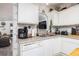 Bright kitchen featuring stainless steel sink, appliances, and white cabinetry at 4100 Ernest Dr, Wesley Chapel, FL 33543