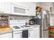 Functional kitchen with range, microwave, stainless refrigerator, and ample storage at 4100 Ernest Dr, Wesley Chapel, FL 33543