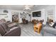 Bright living room with gray flooring, ceiling fan and large TV at 4100 Ernest Dr, Wesley Chapel, FL 33543