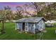 This outbuilding features double doors, convenient ramps, a bench, and exterior shelving for storage at 4100 Ernest Dr, Wesley Chapel, FL 33543