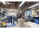 Spacious workshop with exposed beams, multiple workbenches, and an array of tools at 4100 Ernest Dr, Wesley Chapel, FL 33543