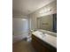 Bright bathroom featuring a shower-tub combo and a single sink vanity at 455 Alt 19 S # 217, Palm Harbor, FL 34683