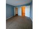 Bedroom showing a doorway to the walk-in closet and attached bath at 455 Alt 19 S # 217, Palm Harbor, FL 34683