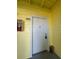 Close-up of an condo unit's entrance door with a security lock and a small storage box at 455 Alt 19 S # 217, Palm Harbor, FL 34683