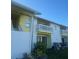 Condo building with a balcony, well-maintained landscaping, and a sunny disposition at 455 Alt 19 S # 217, Palm Harbor, FL 34683