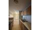 Kitchen featuring a double sink, wooden cabinets, and stainless-steel appliances at 455 Alt 19 S # 217, Palm Harbor, FL 34683