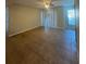 Bright living room featuring tiled flooring, a large sliding glass door, and a ceiling fan at 455 Alt 19 S # 217, Palm Harbor, FL 34683