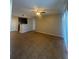 Spacious living room featuring neutral walls, tile flooring, and a ceiling fan with integrated lighting at 455 Alt 19 S # 217, Palm Harbor, FL 34683
