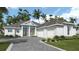 Charming single-story home boasts lush landscaping, a paved driveway, and a welcoming covered porch at 5050 Elm Leaf Dr, Brooksville, FL 34601