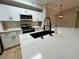 Modern kitchen with white cabinets, stainless steel appliances, and large island with a black faucet at 5618 Pinnacle Heights Cir # 104, Tampa, FL 33624