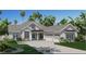 Charming single-story home featuring a paved driveway and lush tropical landscaping at 5837 Creek Ridge Rd, Brooksville, FL 34601