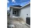 Back exterior of a modern home featuring a covered porch and lots of yard space at 7263 Kodiak Ln, Sarasota, FL 34240