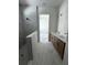 Beautiful bathroom featuring double vanity, tile floors, and a shower stall with marbled tile at 7263 Kodiak Ln, Sarasota, FL 34240